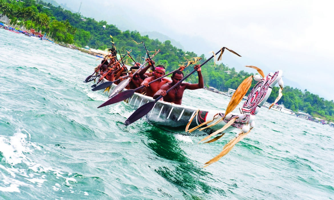 Paddling hard at the Milne Bay Canoe Festival,  Milne Bay