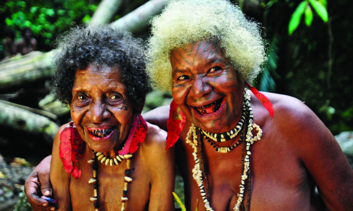 Ladies with traditional face tattoo laughing, Tufi