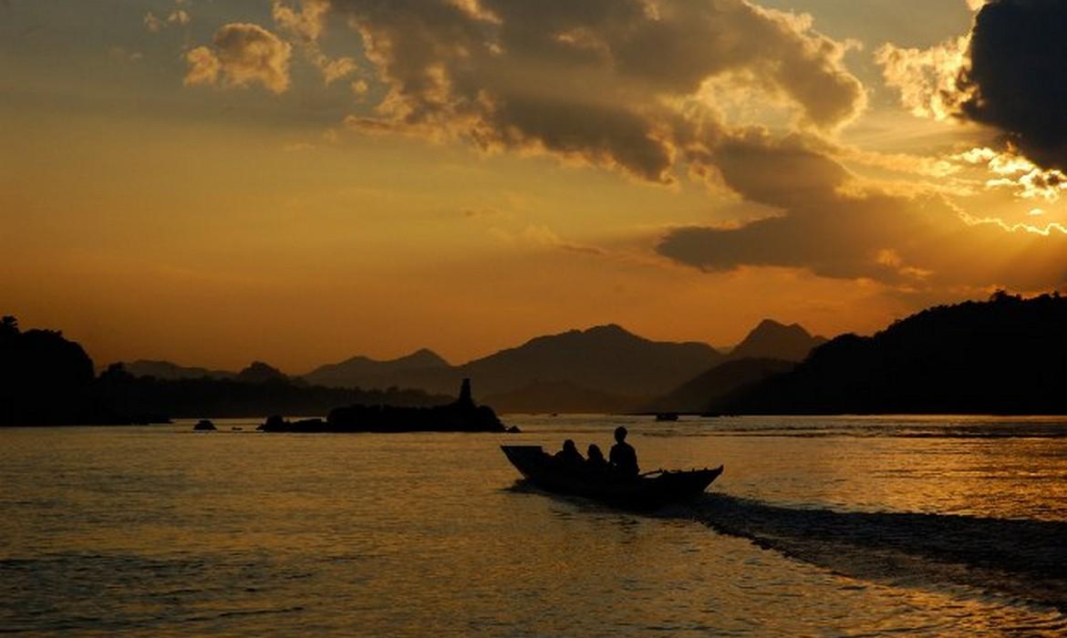 Boat on Mekong at sunset
